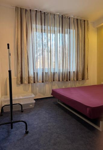 a bedroom with a large bed and a window at Hub Property in Góra Kalwaria