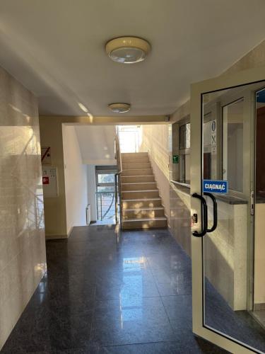 an empty hallway with stairs in a building at Hub Property in Góra Kalwaria