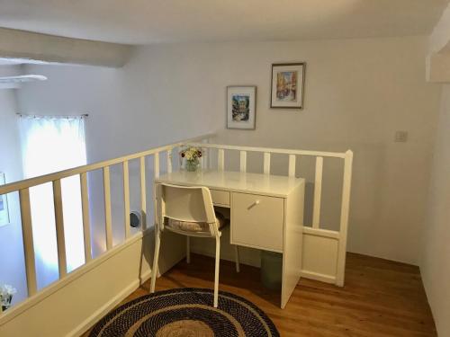 a white desk with a chair in a room at Petit cocon in Villefranche-sur-Mer