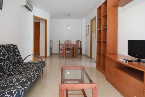 a living room with a couch and a table at UHC Larimar Family Complex in Salou