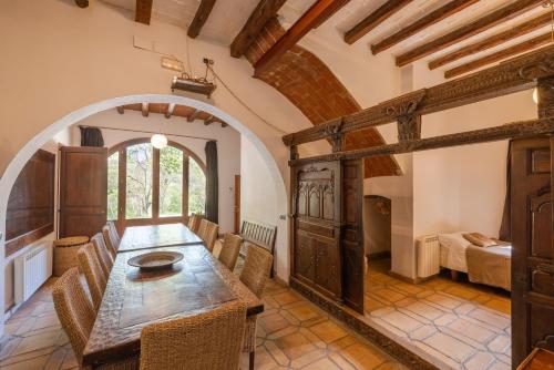 a dining room with a wooden table and chairs at Casa Argentera Full House in Argentera