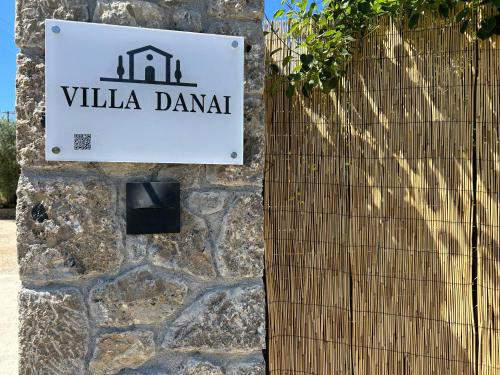 a sign for a villa dana on a stone wall at Villa Danai in Gouvia