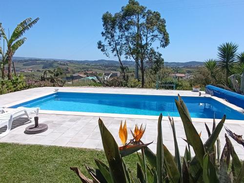 a large swimming pool in a yard with at Gîte CANTO AZUL in Casal da Carreira