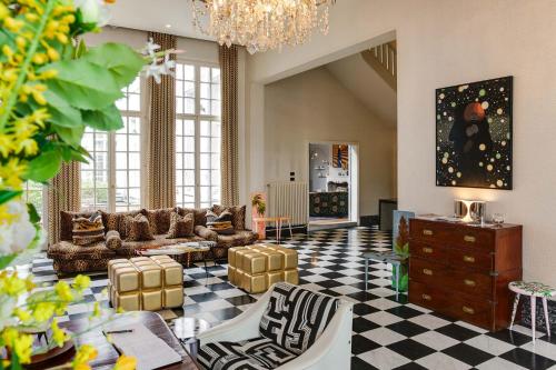 a living room with a checkered floor at Hotel De Witte Lelie -Small Luxury Hotels of the World in Antwerp