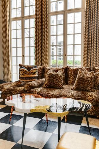 a living room with a couch and a table at Hotel De Witte Lelie -Small Luxury Hotels of the World in Antwerp