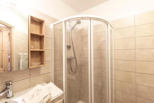 a shower with a glass door in a bathroom at Les Laouchets - Chalet 8 pers in Sixt