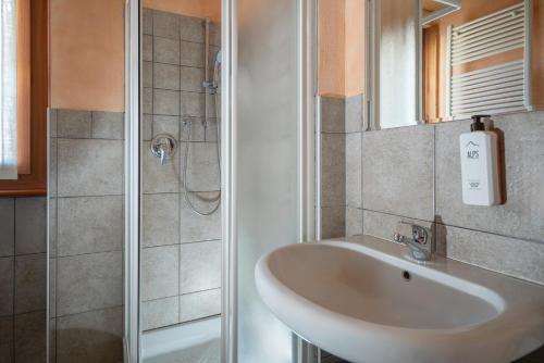 a bathroom with a sink and a shower at Chalet Stelle Di Neve in Bormio