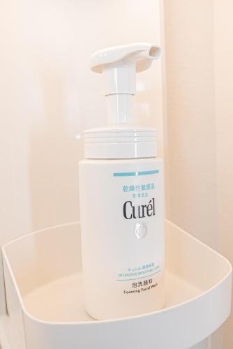 a large white bottle of glue sitting on a shelf at Shinjuku Terrace 226 BnB in Tokyo