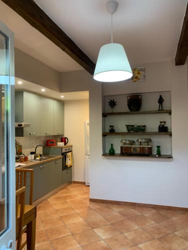 a kitchen with a light hanging from a ceiling at La casa di Barbara in Le Cerquete