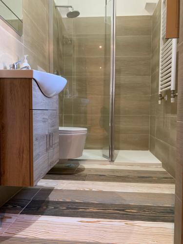 a bathroom with a shower and a toilet and a sink at La casa di Barbara in Le Cerquete