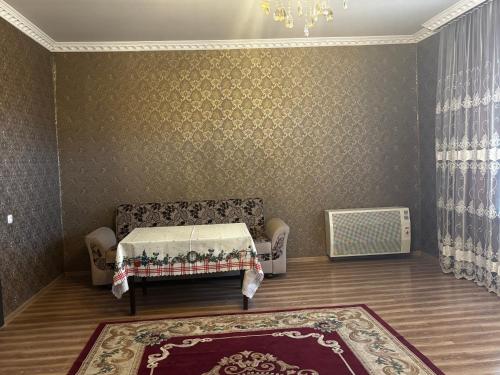 a living room with a bed and a rug at Uplistsikhe guest "Paluma" in Kʼvakhvreli