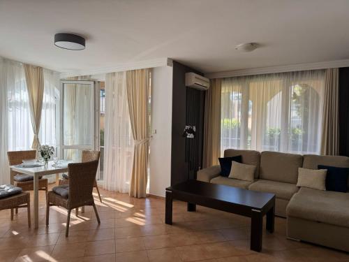 a living room with a couch and a table at Atia Resort in Chernomorets