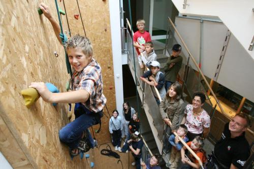 a group of children on a climbing wall at Apartmenthaus SportCHALET in Bad Dürrheim