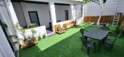 a patio with a table and chairs and plants at INN My Place in Selargius