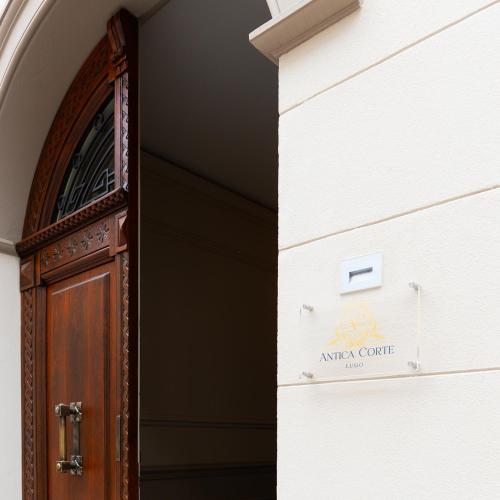 an entrance to a building with a wooden door at Antica Corte Lugo in Lugo