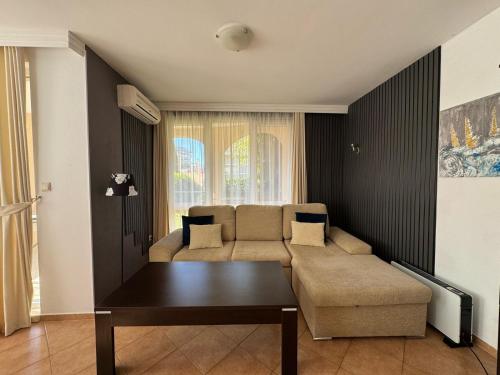 a living room with a couch and a table at Atia Resort in Chernomorets