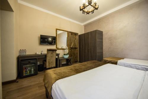 a hotel room with a bed and a fireplace at Passage Antique Hotel in Baku