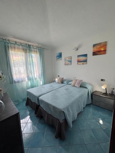 Postel nebo postele na pokoji v ubytování Su Nuraghe House