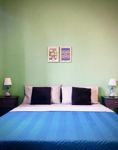 a bedroom with a blue and white bed with two lamps at Casa Costa in Lipari