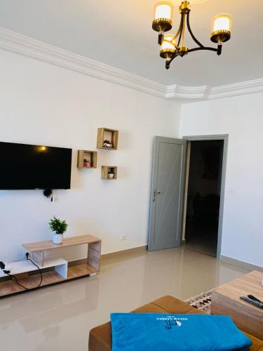 a living room with a tv on the wall at Dream Garden Djerba in Djerba