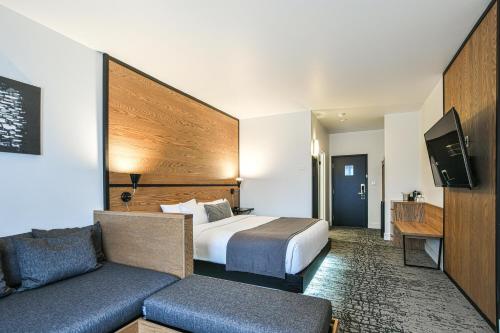a hotel room with a bed and a couch at AX Hotel in Mont-Tremblant