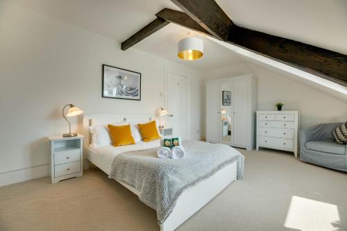 a white bedroom with a bed and a couch at Percy Apartments - By Week2Week in Tynemouth