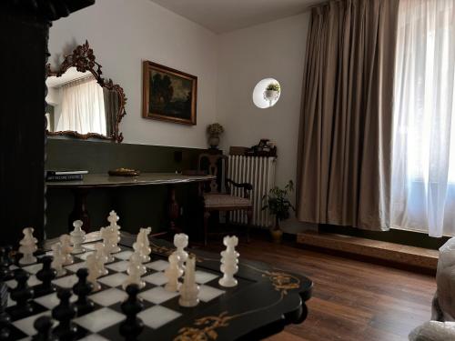 a living room with a chess board on a table at Relais Villa Alma in Castion Veronese