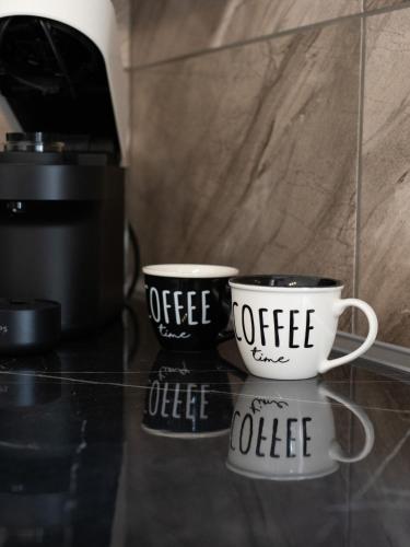 two coffee cups sitting on top of a counter at Natalia's Lovely House in Artemida