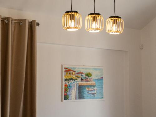 a room with two lights and a painting on the wall at Natalia's Lovely House in Artemida
