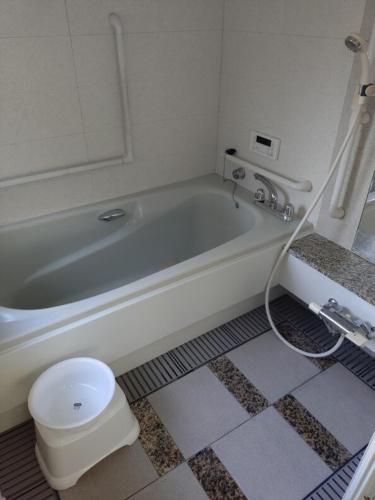 a bathroom with a white tub and a toilet at itoshima 個性的な日本家屋 in Itoshima