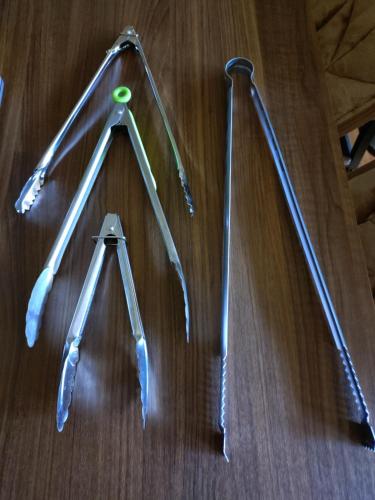 four metal utensils lined up on a wooden table at itoshima 個性的な日本家屋 in Itoshima