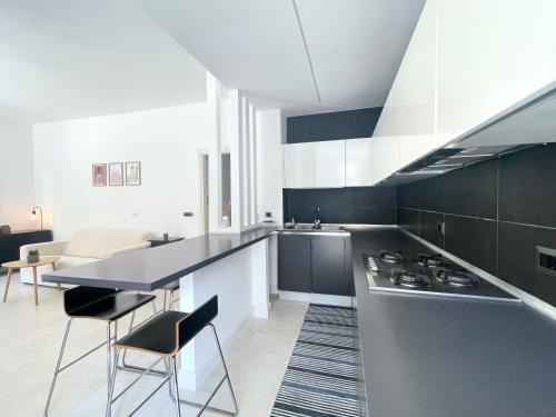 a kitchen with black and white cabinets and a counter at CASA AL FARO - Anzio Centro in Anzio