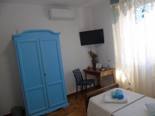 a bedroom with a blue cabinet and a bed at Casa Vacanza LiHele - Locazione Turistica in Castelsardo
