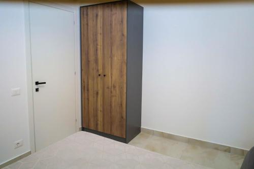a room with white walls and a wooden door at Tritea Apartments in Golem