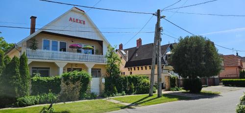 a house with an aico sign on the side of it at Alex's Hajdúszoboszló in Hajdúszoboszló