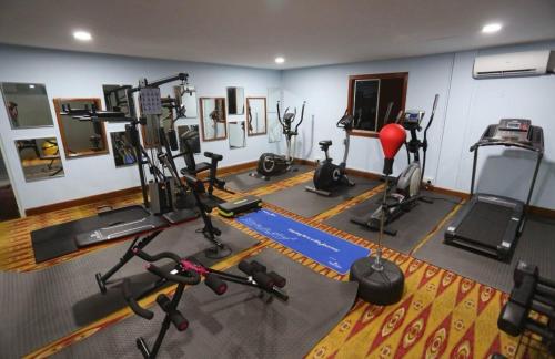 a gym with several exercise equipment in a room at Orkid Hotel at Bukit Bintang in Kuala Lumpur