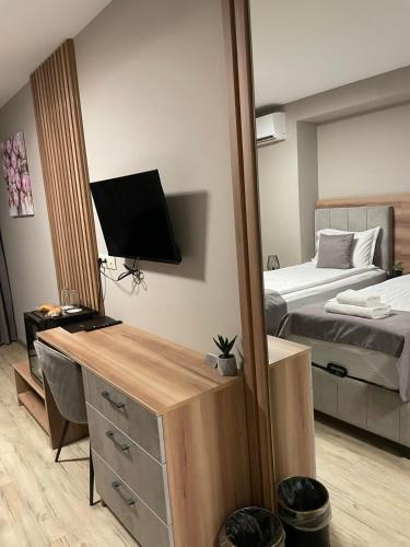 a room with a bedroom with a bed and a mirror at Hotel BLISS Sofia Airport Self Check In in Kazichene