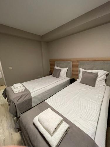 two beds sitting next to each other in a room at Hotel BLISS Sofia Airport Self Check In in Kazichene