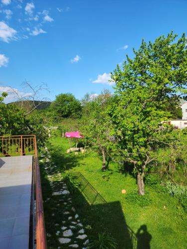 a view of a garden with trees and a bridge at Agroturizem Devin in Qerret