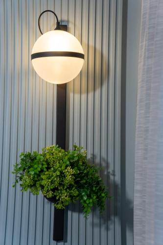 a light fixture with a potted plant under it at Hotel Epavlis Eleftheriadi in Paralia Katerinis