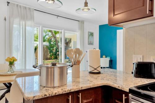 a kitchen with a counter top with a large pot on a counter at The Modern Palms few mins from Downtown Tampa Ybor city in Tampa