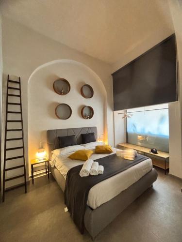 a bedroom with a large bed with a large window at Casa del Pastaio in Catania