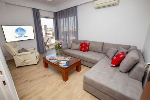 a living room with a couch and a coffee table at Calm Sea in Lávrion