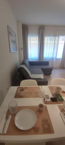 a table with plates and bowls on it in a room at Ariminum Suite - Minimalism and class in the historic center in Rimini