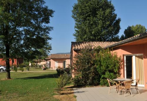 a patio with a table and chairs in front of a house at Domaine d'Agrippa Valence in Châteauneuf-sur-Isère