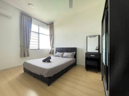 a bedroom with a bed and a mirror and a window at kkLee Homestay Condo Taiping A-4-6 in Taiping