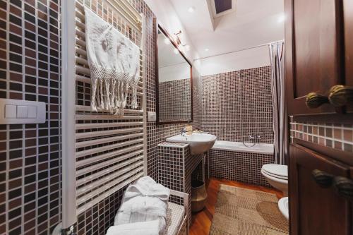 a bathroom with a sink and a toilet at Villa ElSi, Where Relaxation and Elegance Meet in Valenzano