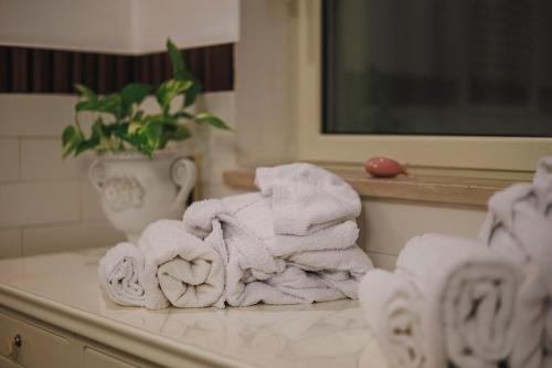 a pile of towels on a counter in a bathroom at Villa ElSi, Where Relaxation and Elegance Meet in Valenzano