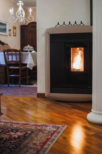 a fireplace in a living room with a table at Villa ElSi, Where Relaxation and Elegance Meet in Valenzano