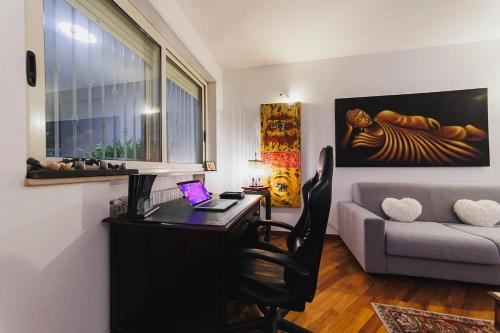 a living room with a desk and a couch at Villa ElSi, Where Relaxation and Elegance Meet in Valenzano